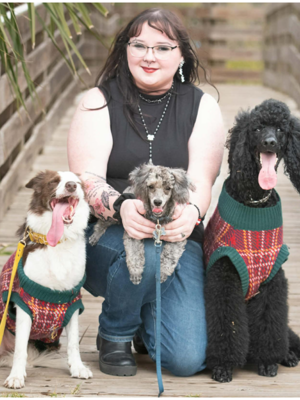 Lynn, founder of Indigo Canines, with a dog in a natural outdoor setting